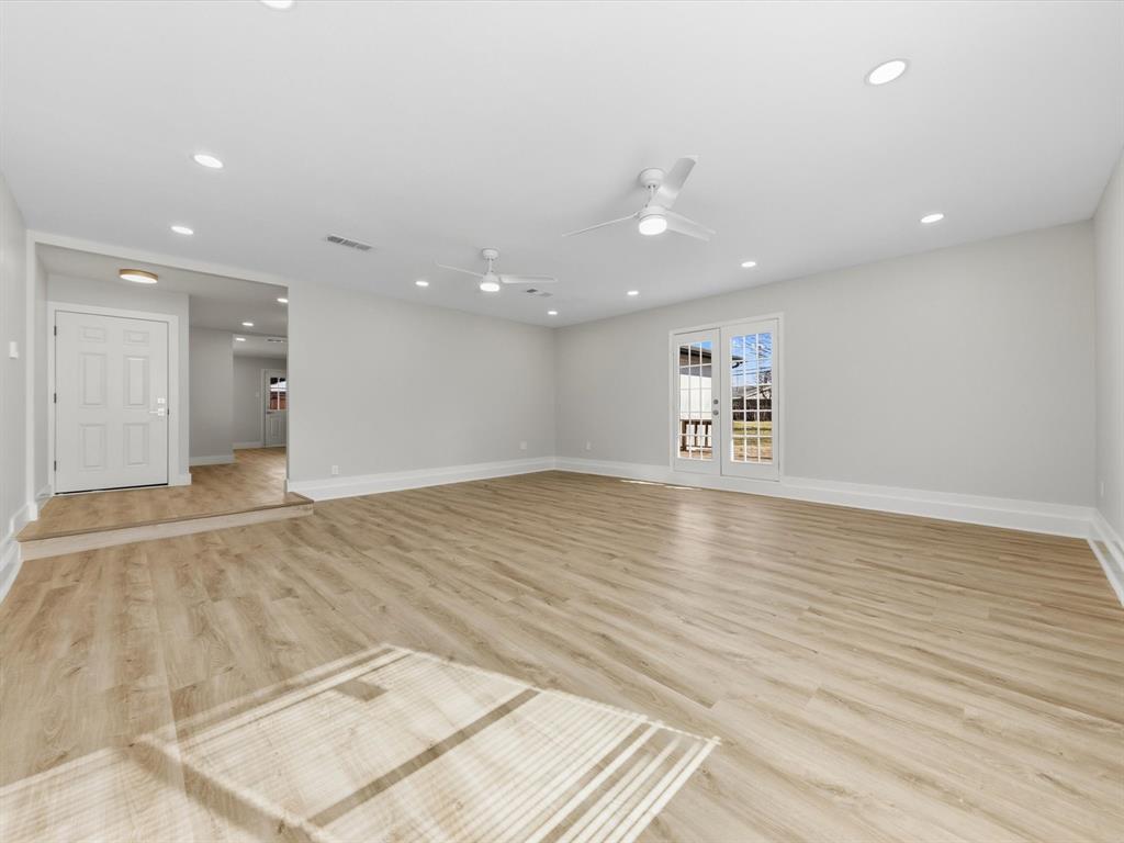 4013 Oleander Trail Mesquite, TX 75150 - Photo 3 of 28 Empty room with light wood-style flooring, recessed lighting, and ceiling fan