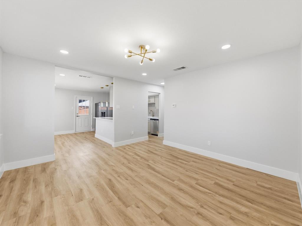 4013 Oleander Trail Mesquite, TX 75150 - Photo 4 of 28 Unfurnished living room with a chandelier, light wood finished floors, and recessed lighting
