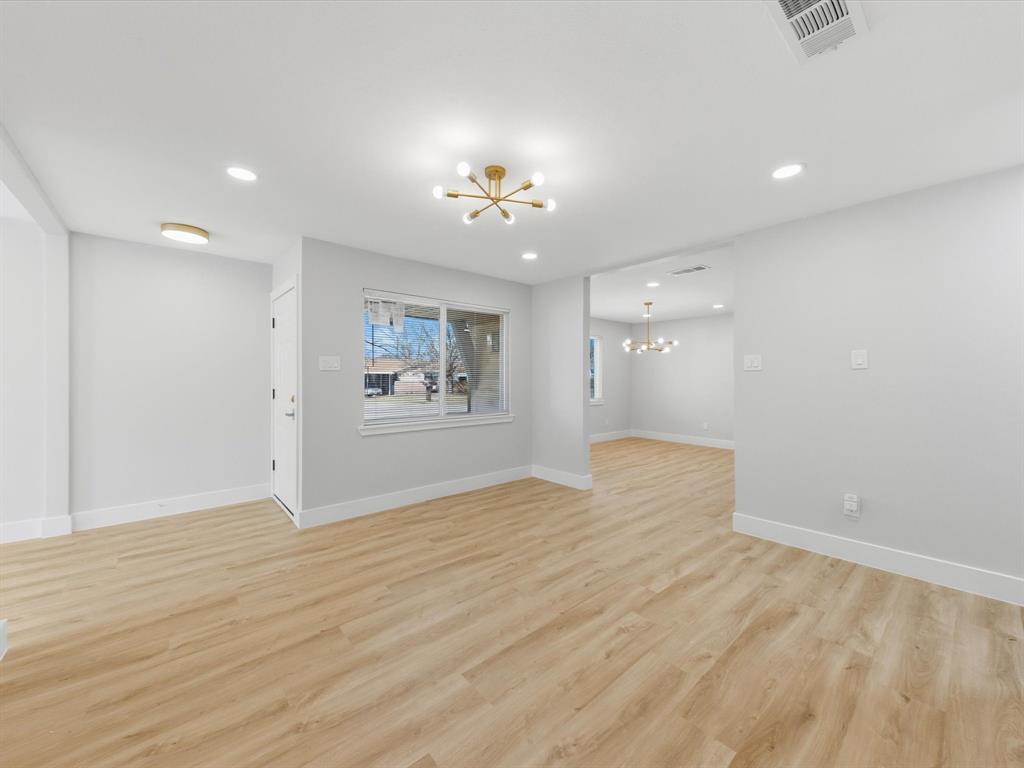 4013 Oleander Trail Mesquite, TX 75150 - Photo 5 of 28 Spare room with a chandelier, light wood-style floors, and recessed lighting