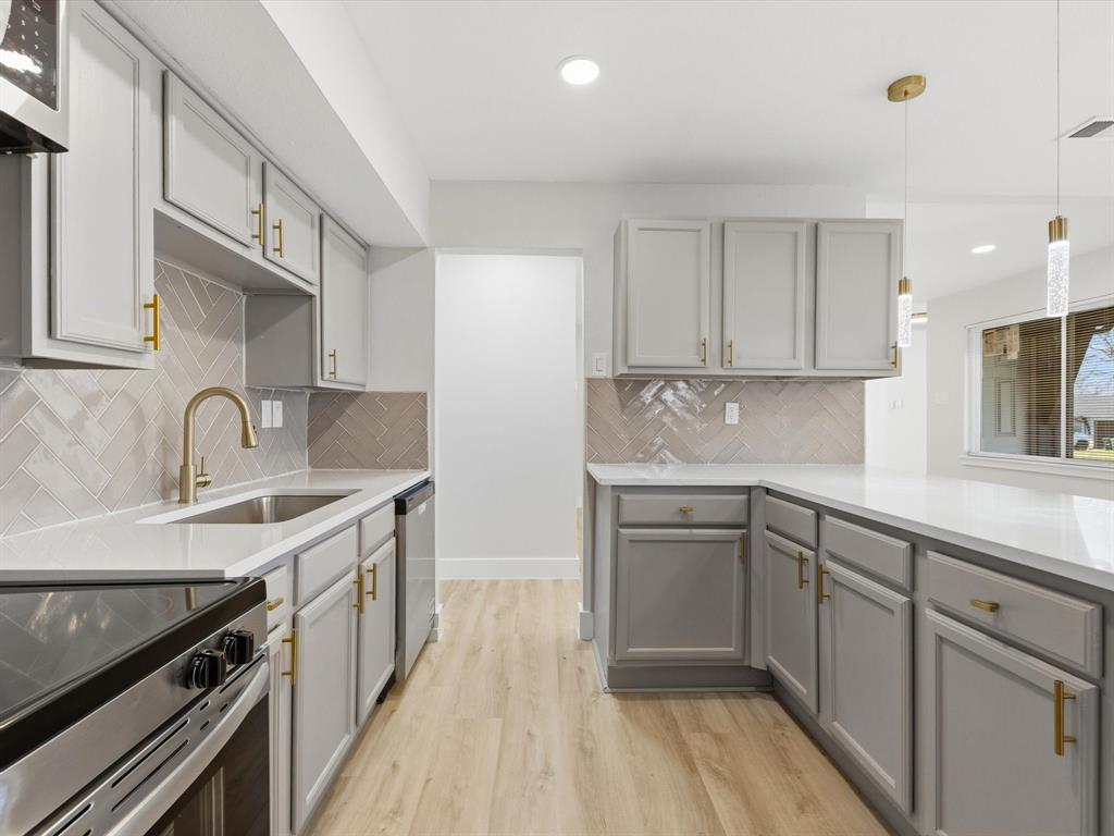 4013 Oleander Trail Mesquite, TX 75150 - Photo 8 of 28 Kitchen with gray cabinetry, pendant lighting, light wood-type flooring, recessed lighting, and light stone counters