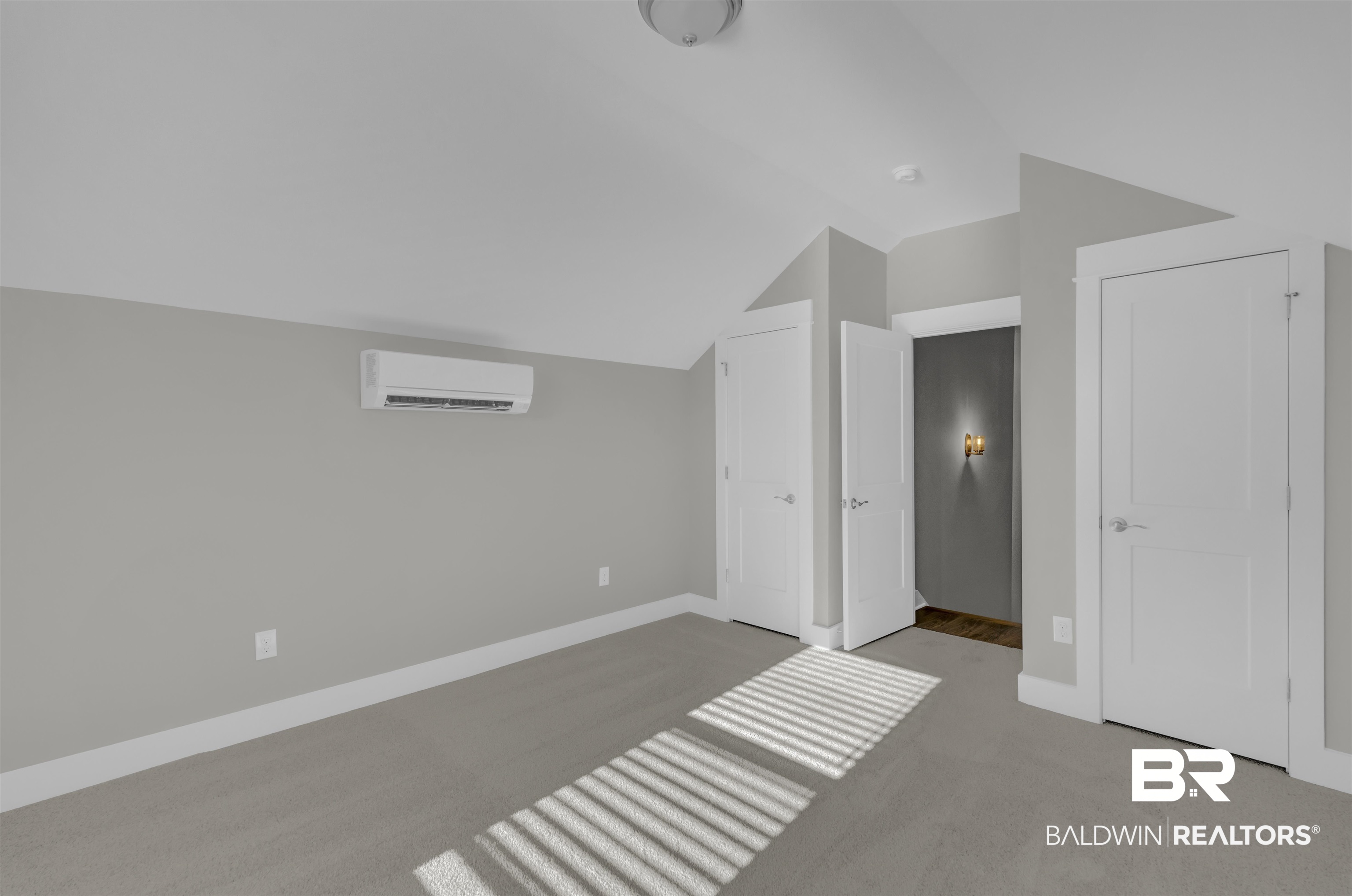 571 Morning Mist Way Fairhope, AL 36532 - Photo 34 of 47 Unfurnished bedroom featuring vaulted ceiling, light carpet, a closet, and an AC wall unit
