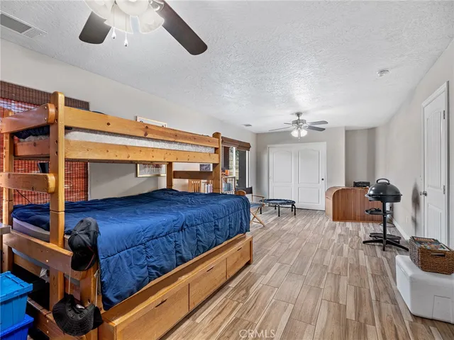 a kitchen with stainless steel appliances granite countertop a stove a refrigerator a sink a dining table and chairs