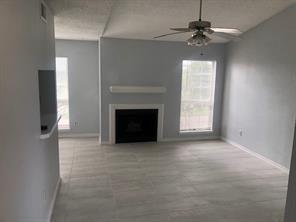 3645 West Northgate Drive, Unit 202 Irving, TX 75062 - Photo 3 of 12 an empty room with windows and fireplace