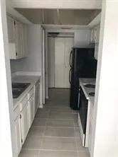 a kitchen with a refrigerator and a stove