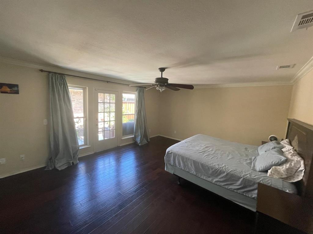 3612 Cross Bend Road Plano, TX 75023 - Photo 23 of 38 Bedroom with dark hardwood / wood-style flooring, ornamental molding, ceiling fan, and access to outside