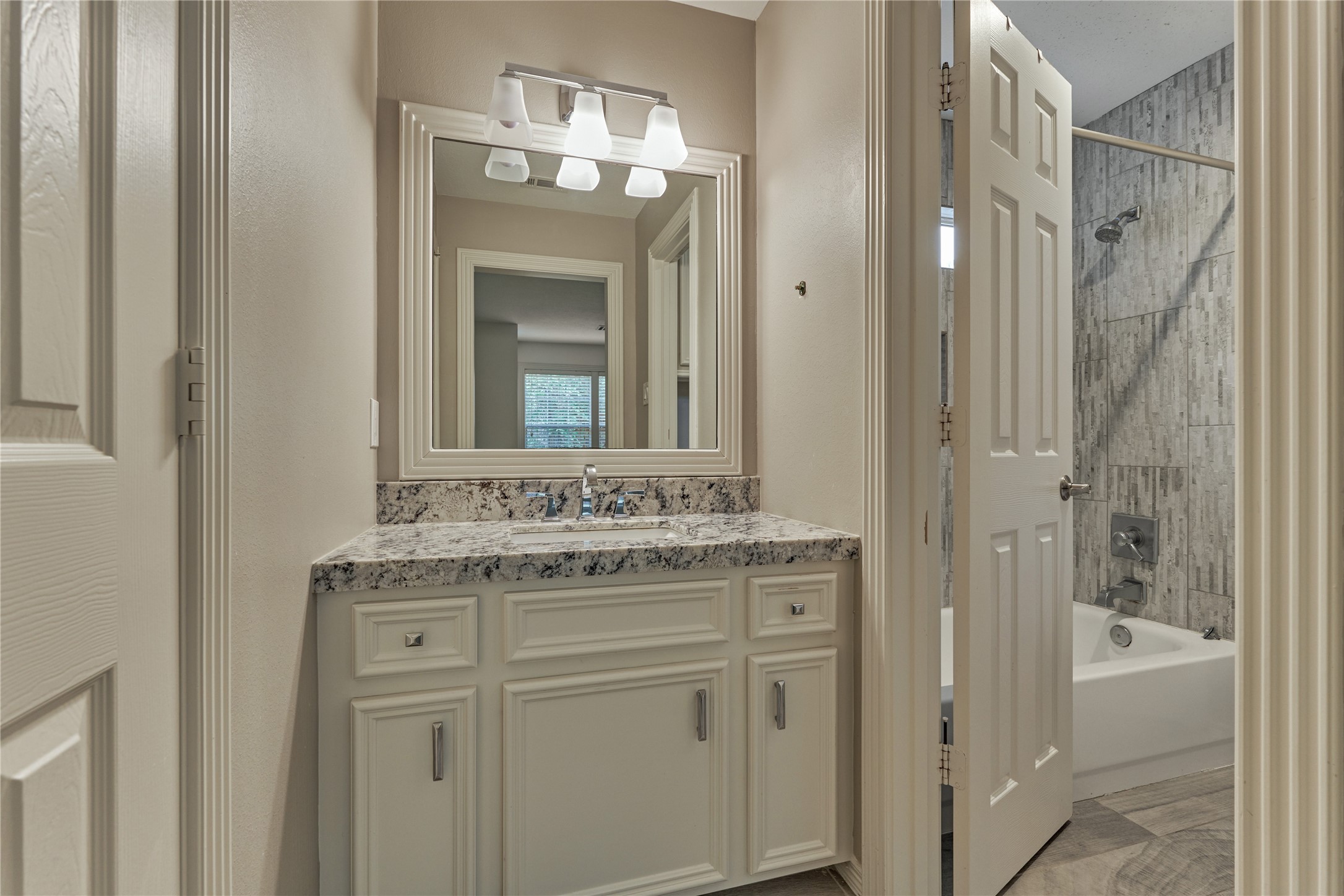 7 Gentry Oak Court Spring, TX 77381 - Photo 36 of 50 a bathroom with a granite countertop sink vanity and a mirror