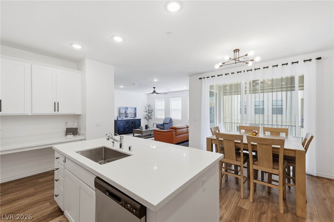 2555 Hampton Road, Unit 7203 Henderson, NV 89052 - Photo 15 of 46 Kitchen features luxury vinyl flooring, recessed lighting, s/s appliances, quartz countertops and island. Showing flow from kitchen to dining area, great room and balcony.