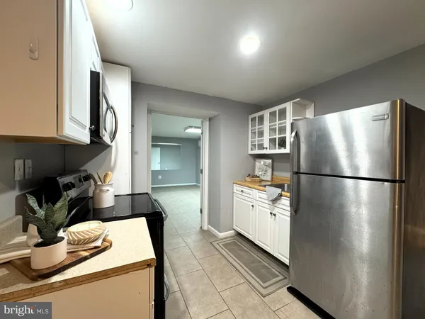 a kitchen with a refrigerator and a stove top oven