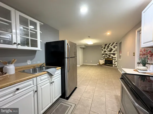 a kitchen with stainless steel appliances a refrigerator sink and cabinets