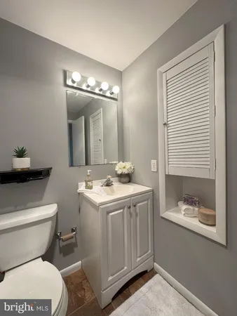 a bathroom with a toilet sink and mirror