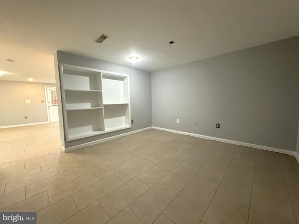 an empty room with a empty space and windows