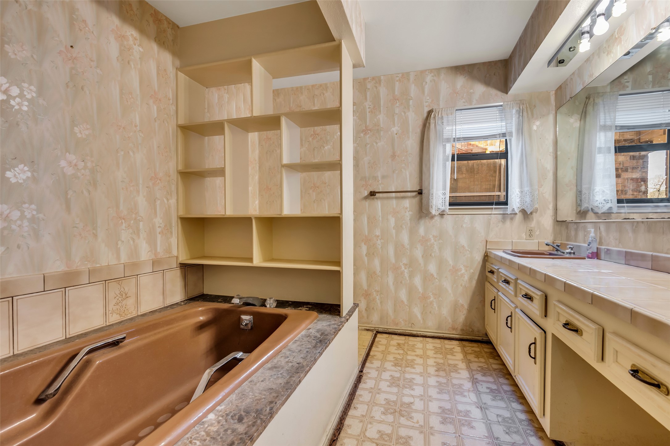 22980 Jade Street Porter, TX 77365 - Photo 16 of 32 a bathroom with a tub sink and mirror