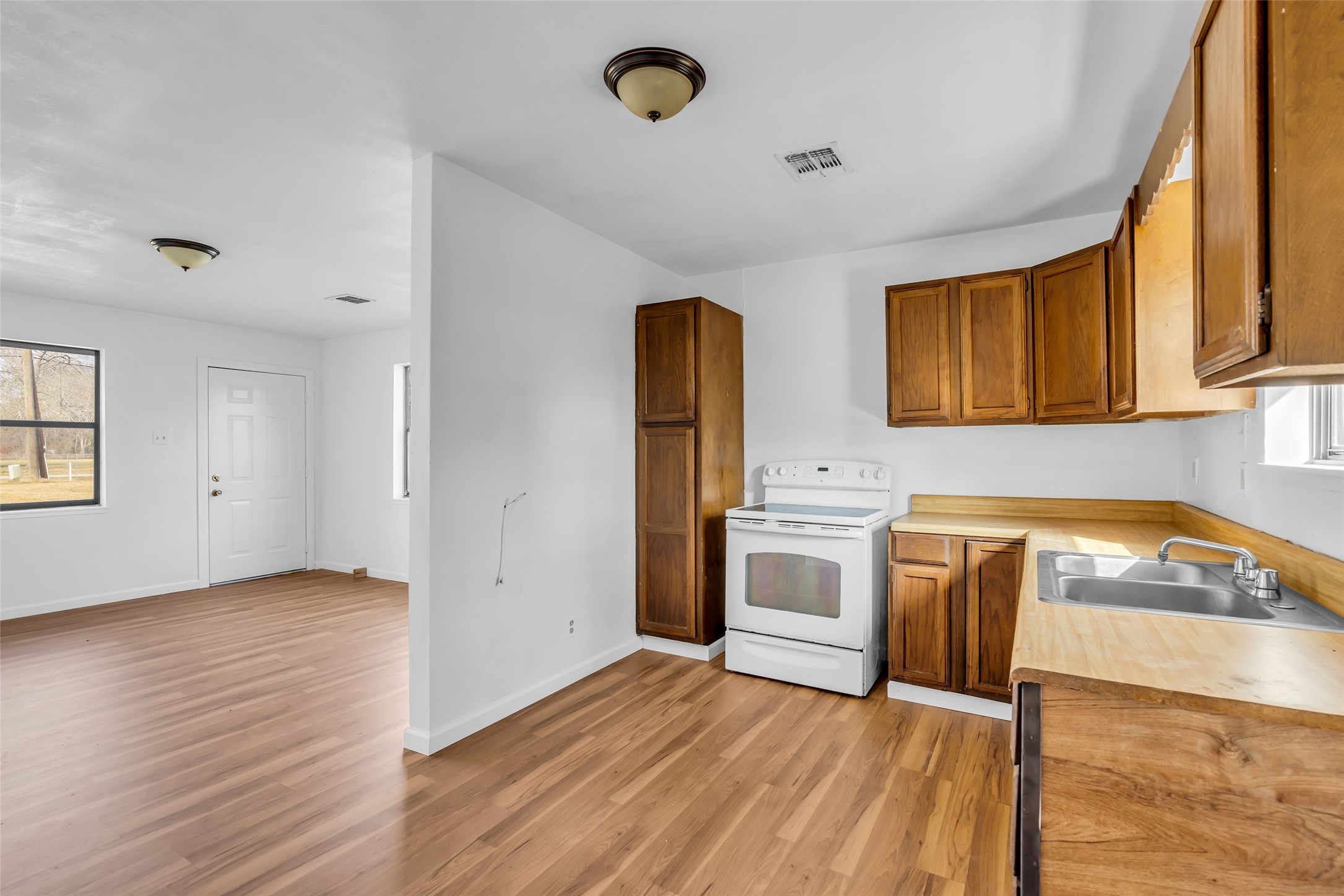 22980 Jade Street Porter, TX 77365 - Photo 21 of 32 a kitchen with granite countertop a sink and a stove top oven