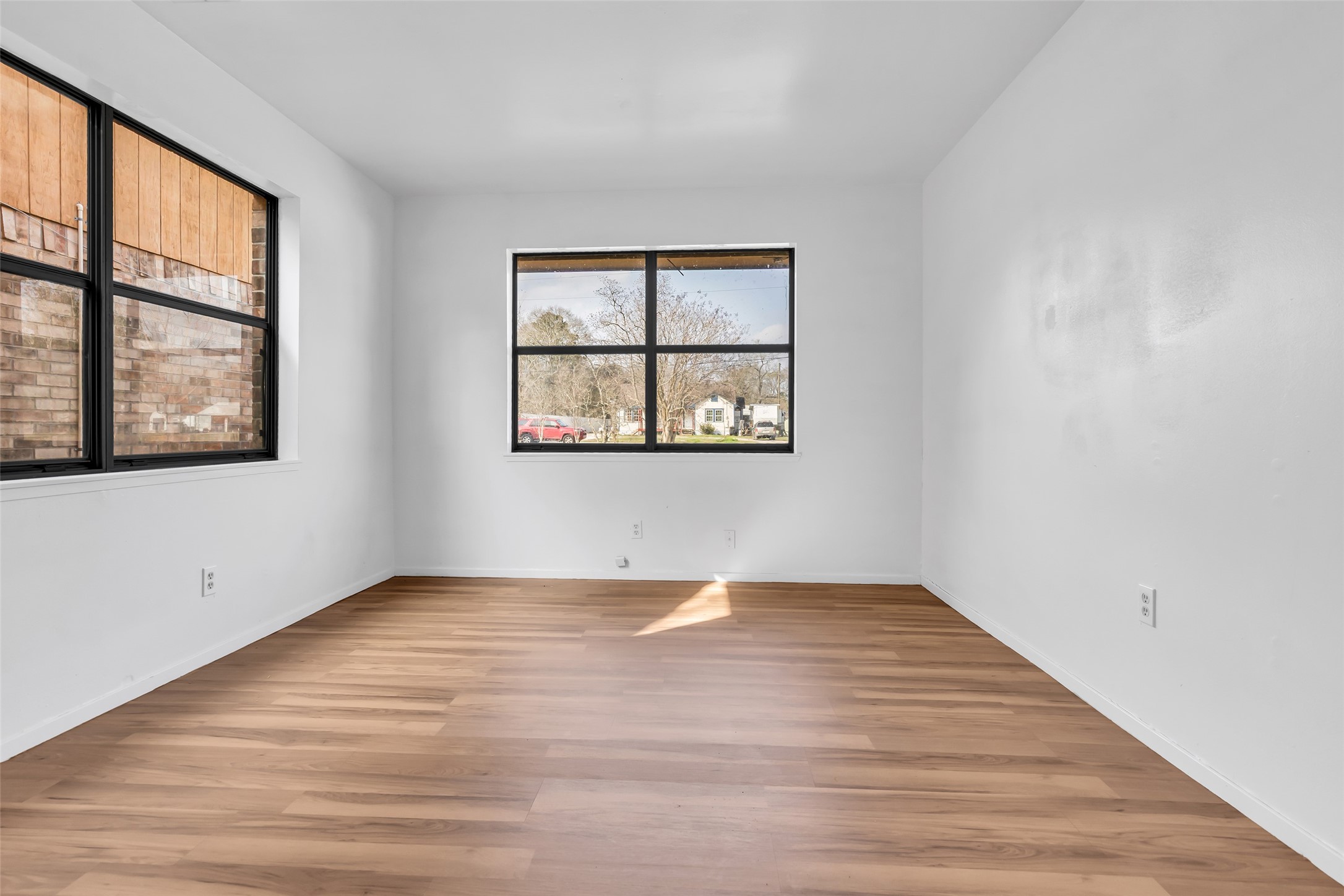 22980 Jade Street Porter, TX 77365 - Photo 22 of 32 a view of an empty room with wooden floor and a window