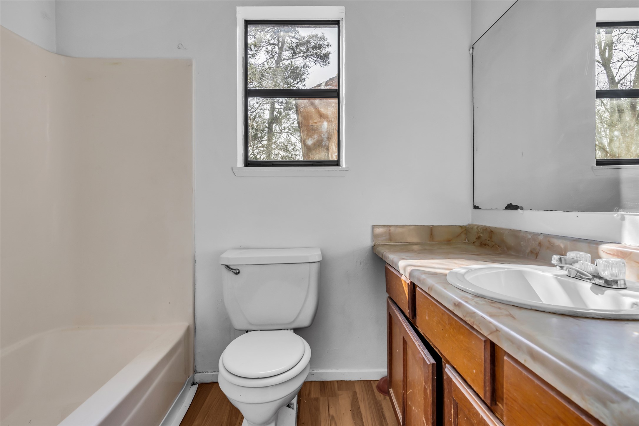 22980 Jade Street Porter, TX 77365 - Photo 23 of 32 a bathroom with a granite countertop toilet sink and mirror