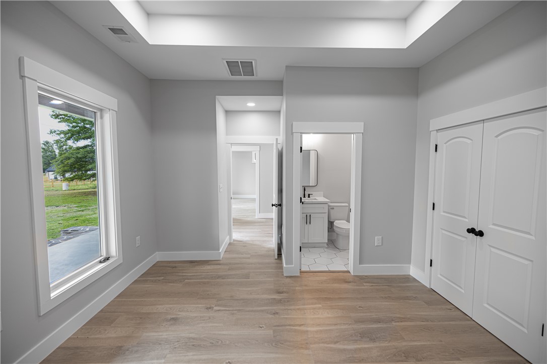 2817 Broadway Lake Road Anderson, SC 29621 - Photo 19 of 41 A versatile open space features durable hardwood-style flooring and direct access to a well-appointed bathroom.