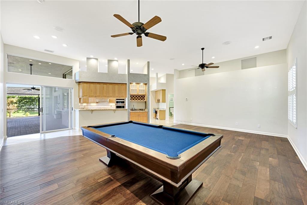 2035 Castle Garden Lane Naples, FL 34110 - Photo 17 of 40 a room with pool table and windows