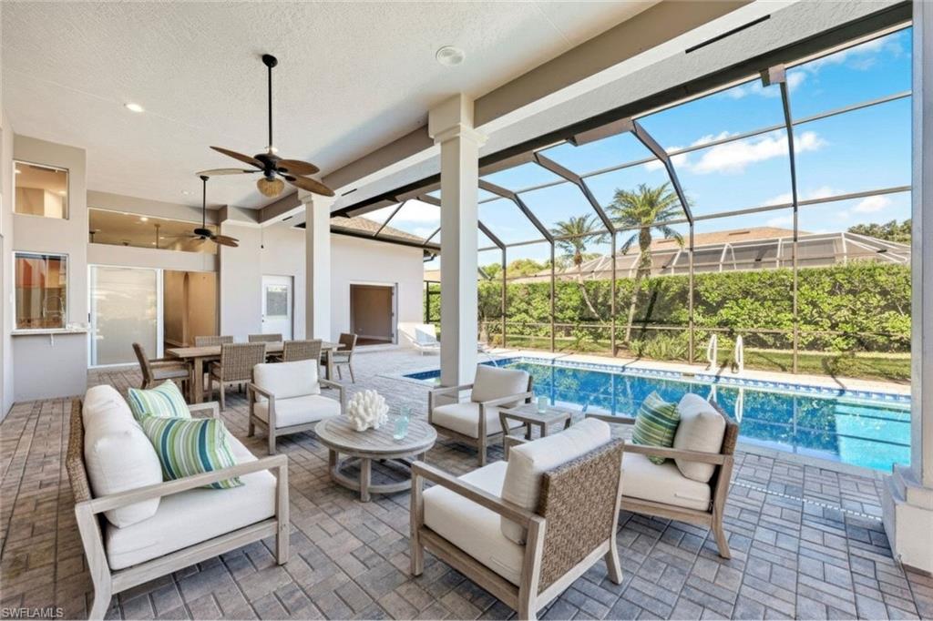 2035 Castle Garden Lane Naples, FL 34110 - Photo 2 of 40 a living room with furniture and a large window