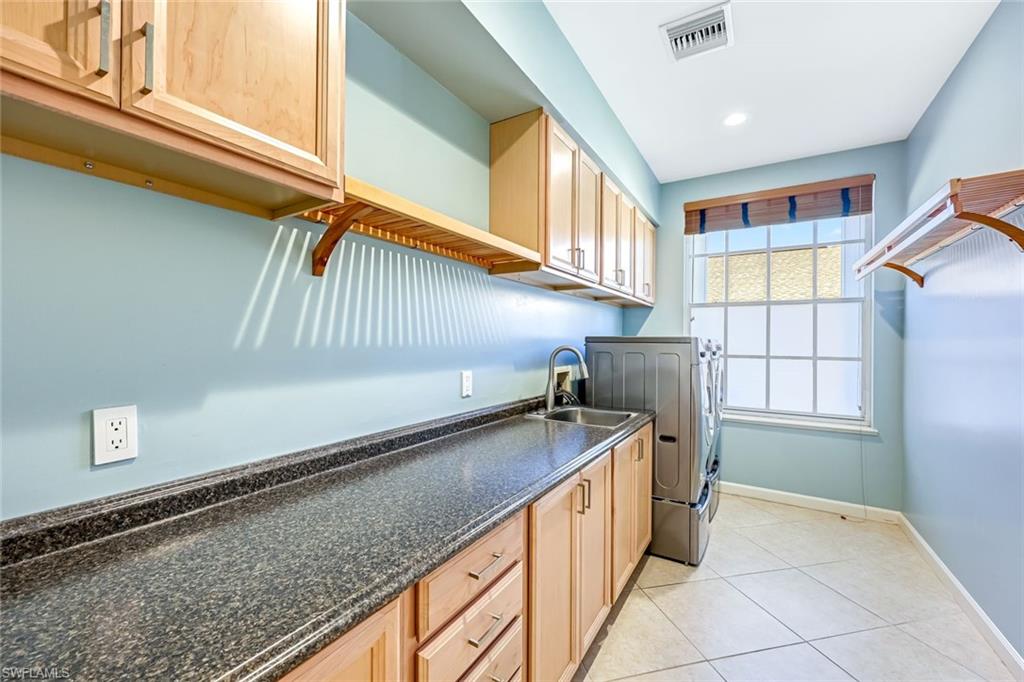 2035 Castle Garden Lane Naples, FL 34110 - Photo 27 of 40 a kitchen with stainless steel appliances granite countertop a sink and a cabinets