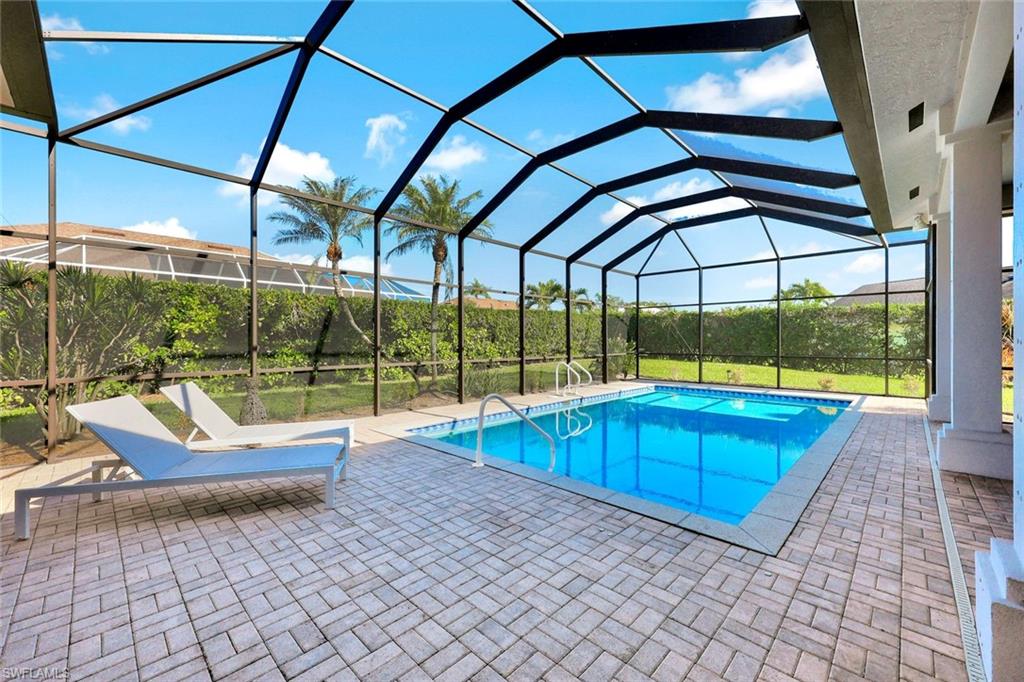 2035 Castle Garden Lane Naples, FL 34110 - Photo 28 of 40 a view of swimming pool with seating area and roof