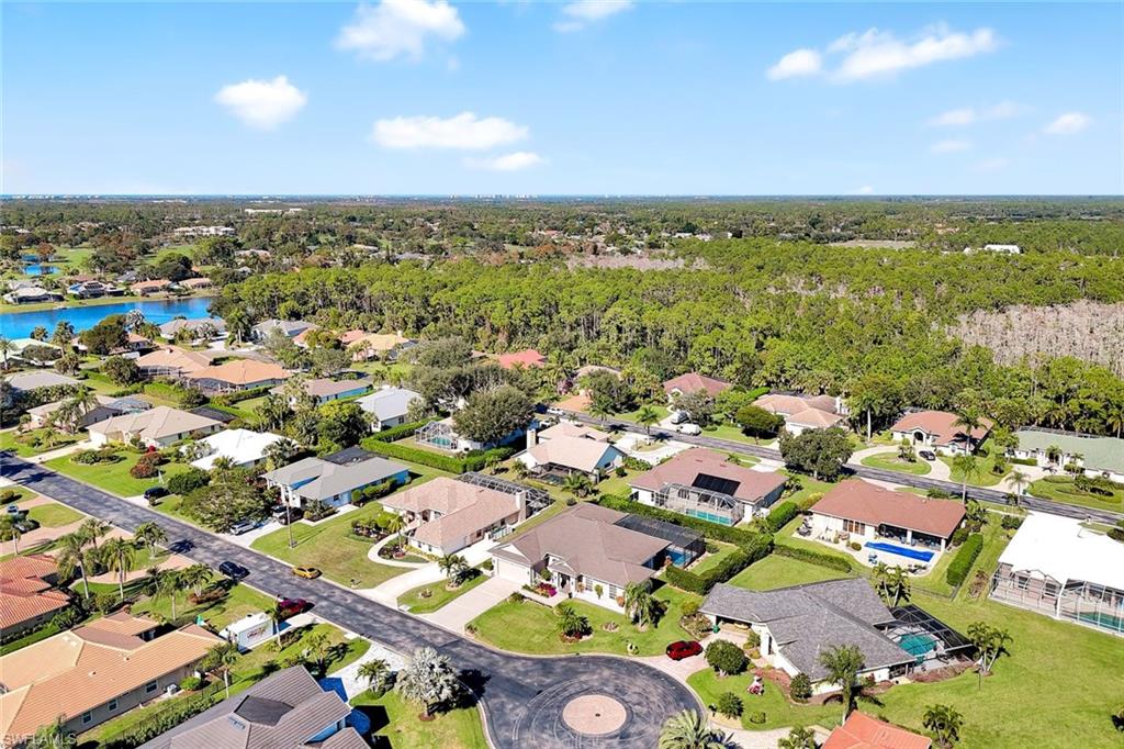 2035 Castle Garden Lane Naples, FL 34110 - Photo 36 of 40 an aerial view of residential houses with outdoor space and trees