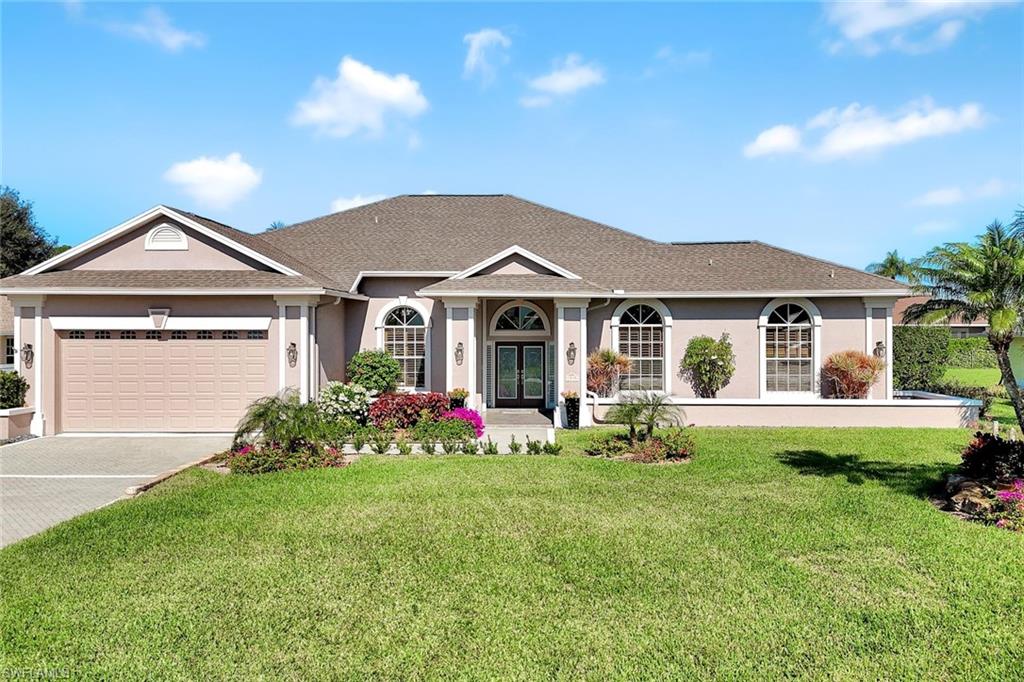 2035 Castle Garden Lane Naples, FL 34110 - Photo 38 of 40 a front view of a house with garden