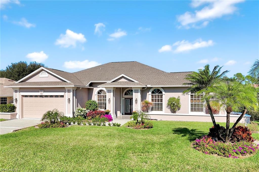 2035 Castle Garden Lane Naples, FL 34110 - Photo 40 of 40 a front view of a house with garden