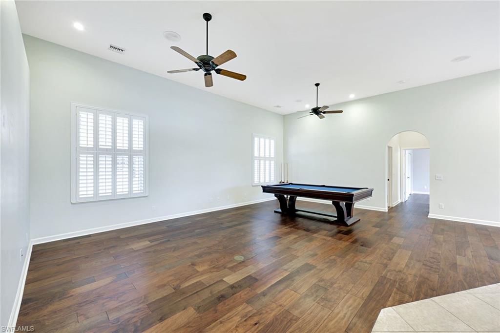 2035 Castle Garden Lane Naples, FL 34110 - Photo 5 of 40 a living room with furniture and a wooden floor
