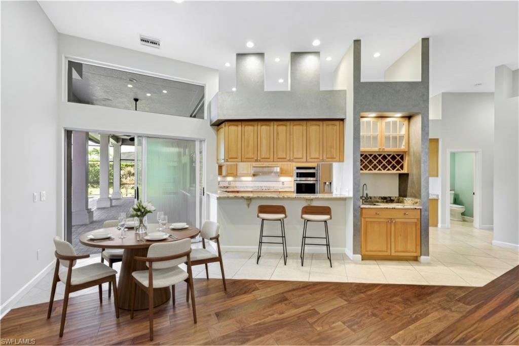 2035 Castle Garden Lane Naples, FL 34110 - Photo 6 of 40 a view of kitchen with cabinets and wooden floor