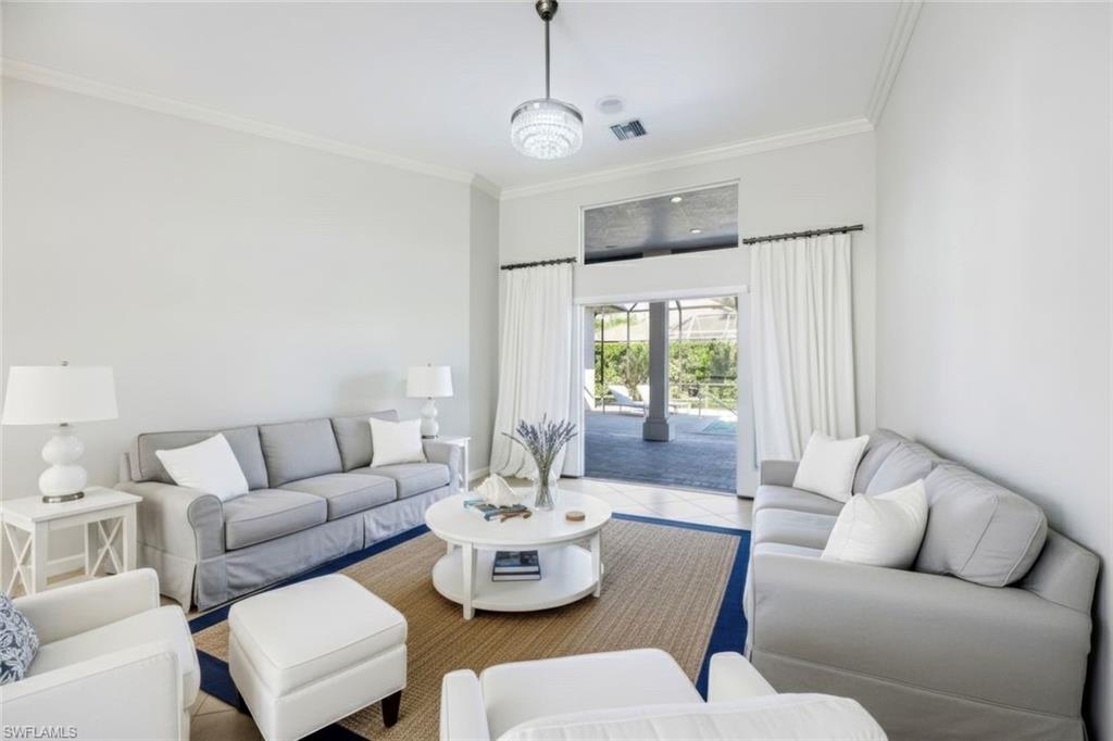 2035 Castle Garden Lane Naples, FL 34110 - Photo 8 of 40 a living room with furniture and a large window