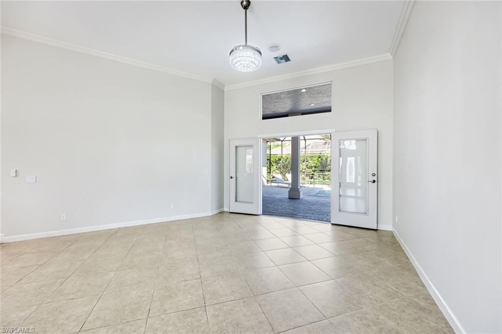 2035 Castle Garden Lane Naples, FL 34110 - Photo 9 of 40 a view of hallway with chandelier and front door