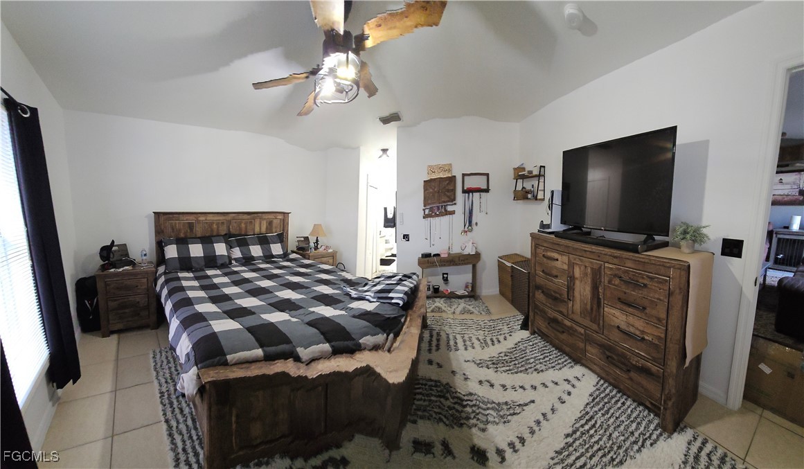 3910 23rd Street Southwest Lehigh Acres, FL 33976 - Photo 16 of 16 a bedroom with furniture and flat screen tv