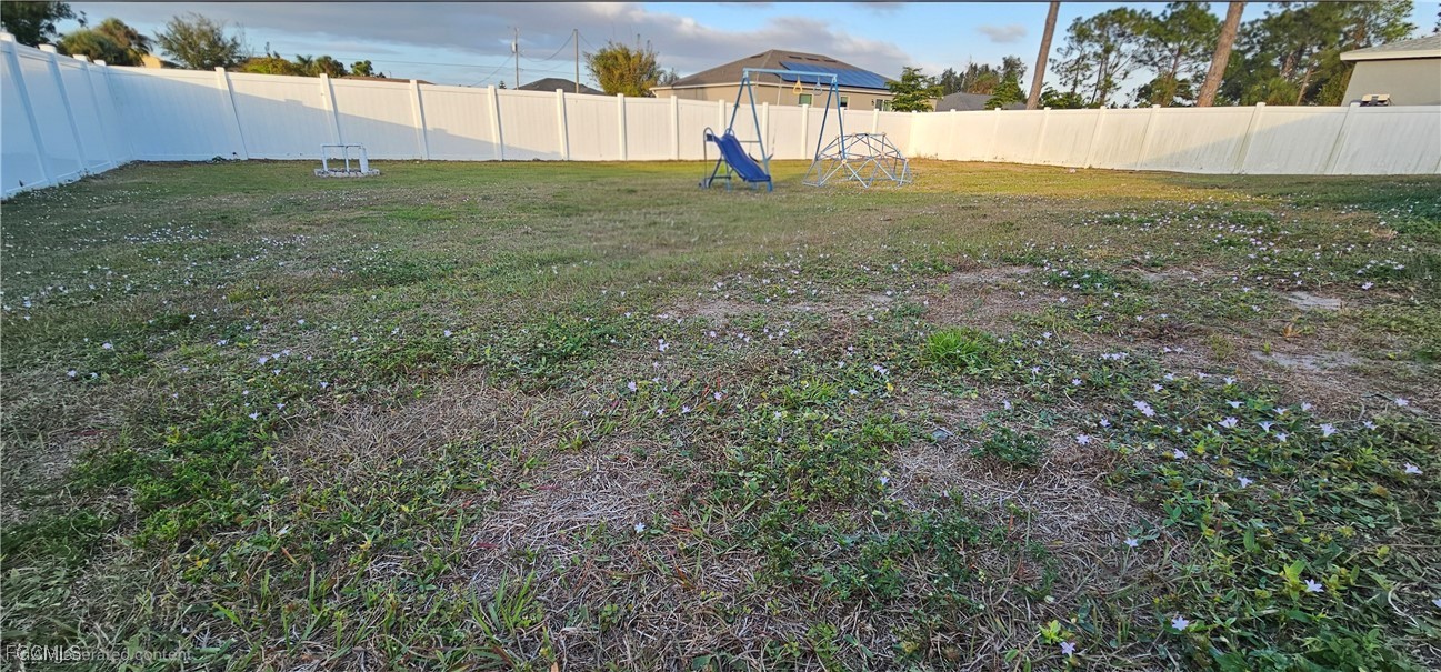 3910 23rd Street Southwest Lehigh Acres, FL 33976 - Photo 8 of 16 a view of an outdoor space and a yard