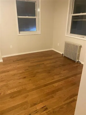 a view of a room with wooden floor and white walls