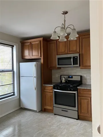 a kitchen with stainless steel appliances granite countertop a stove and a microwave