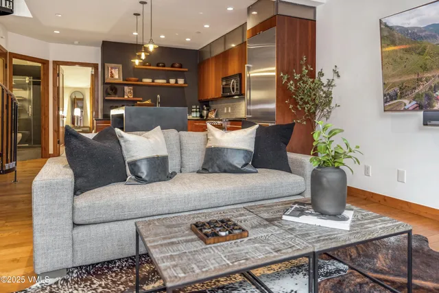 a living room with furniture and a potted plant