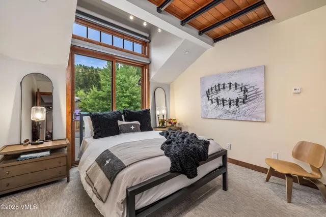 a spacious bedroom with a bed a couch and a window