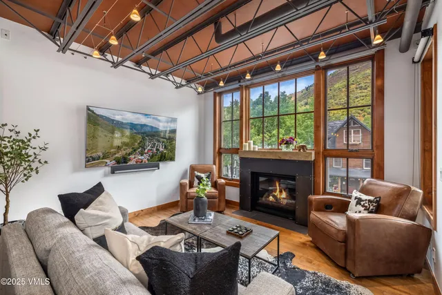 a living room with furniture a fireplace and a flat screen tv