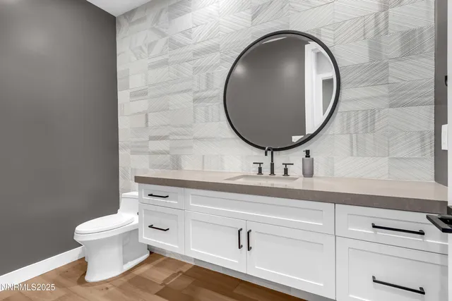 a bathroom with a toilet a sink and a mirror