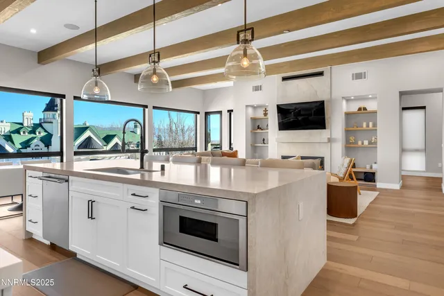 a kitchen with stainless steel appliances kitchen island a large counter space a sink and appliances