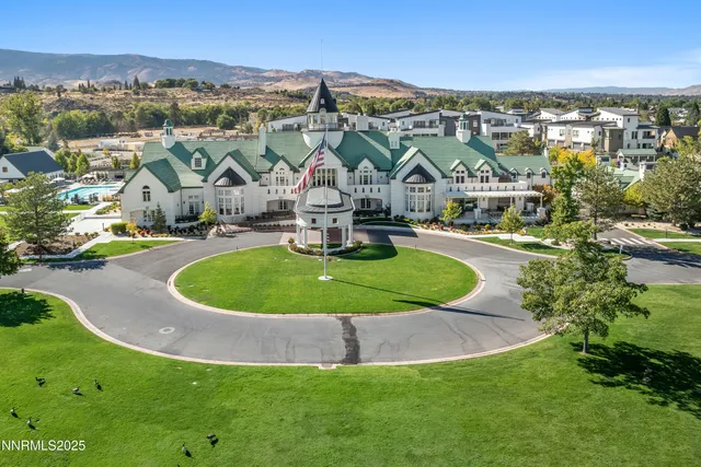 an aerial view of a house with a big yard and large tree