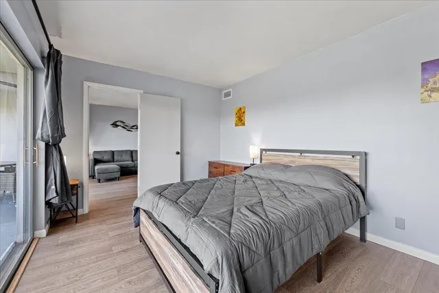 a bedroom with a bed and a large window