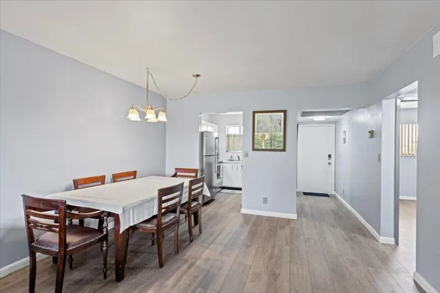 a view of hallway with closet and wooden floor