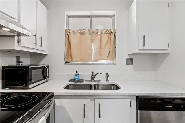 a very nice looking room with a large window and furniture