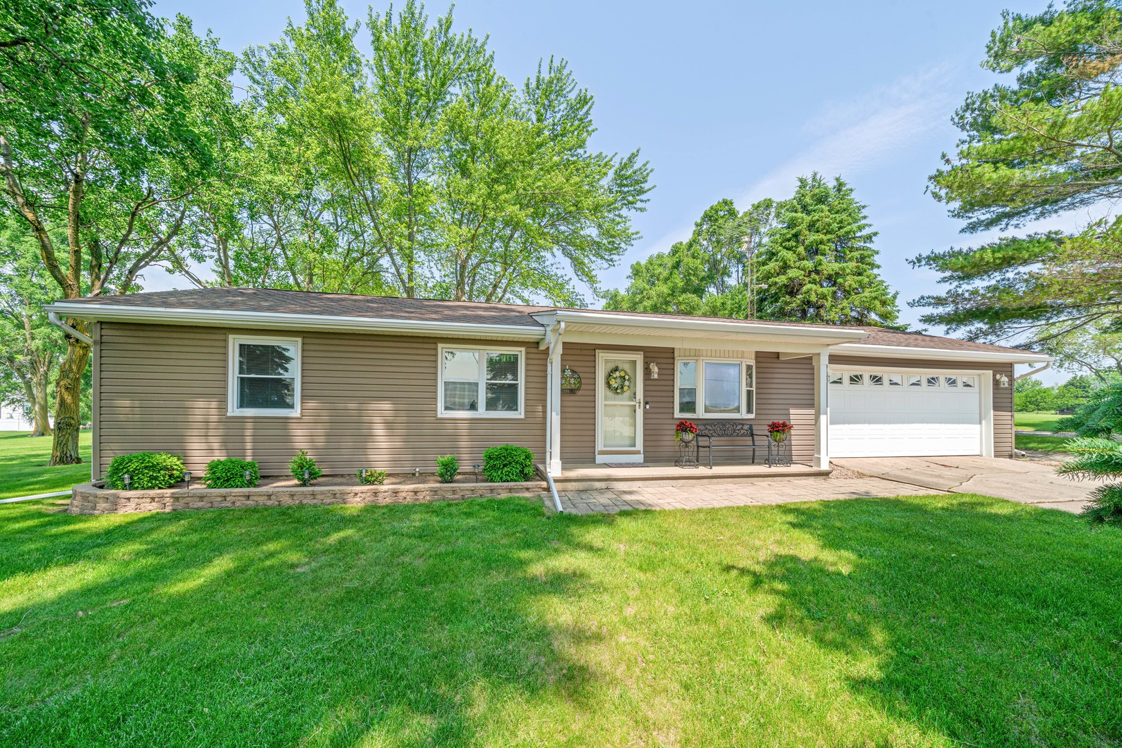 14893 Plank Road Sycamore, IL 60178 - Photo 1 of 33 a front view of house with a garden and trees
