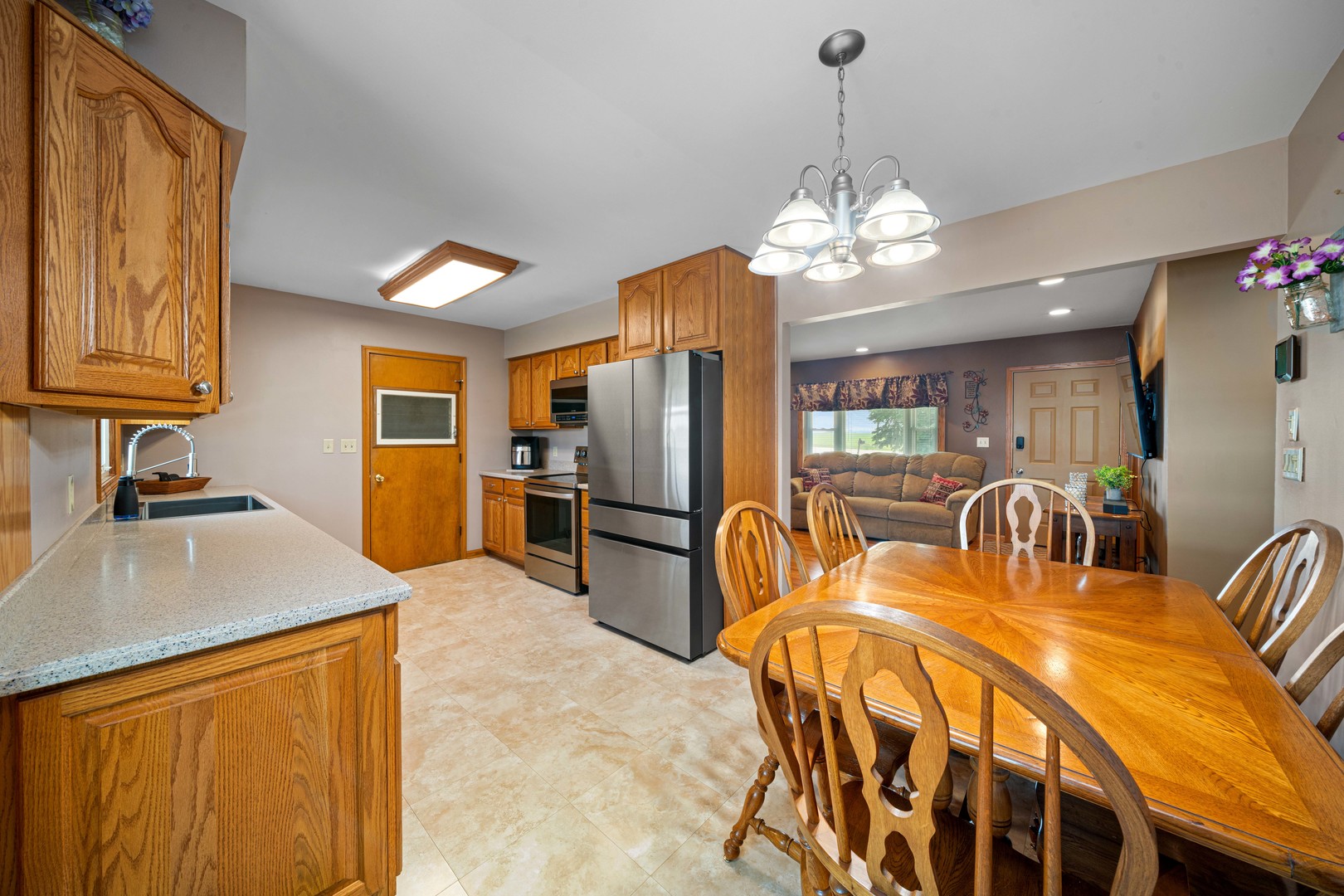 14893 Plank Road Sycamore, IL 60178 - Photo 16 of 33 a kitchen with stainless steel appliances granite countertop a sink a stove and a refrigerator