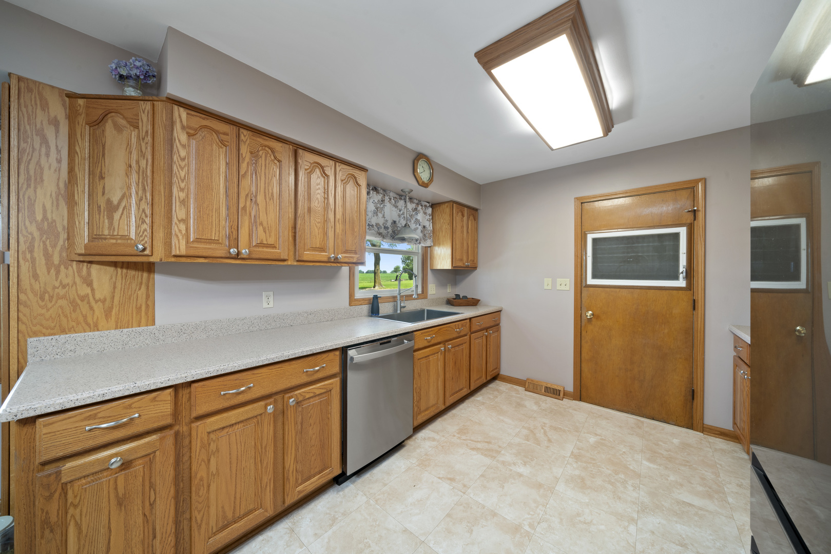 14893 Plank Road Sycamore, IL 60178 - Photo 17 of 33 a kitchen with stainless steel appliances granite countertop cabinets and window