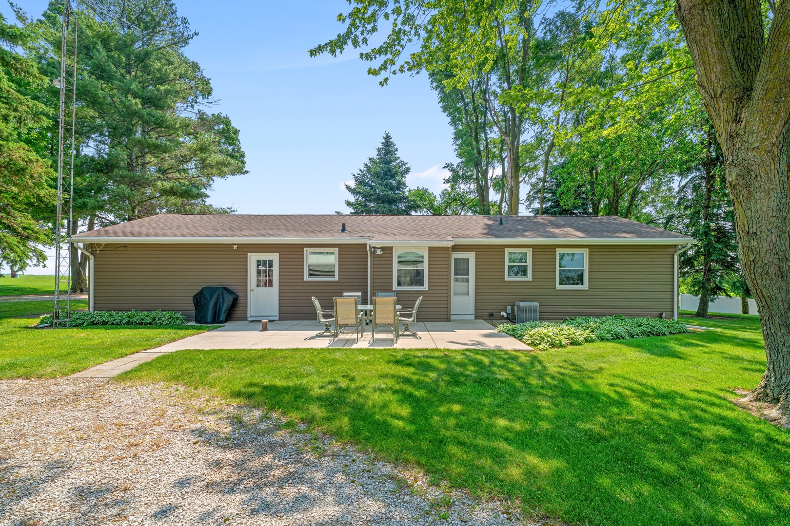 14893 Plank Road Sycamore, IL 60178 - Photo 7 of 33 a front view of a house with a yard and trees