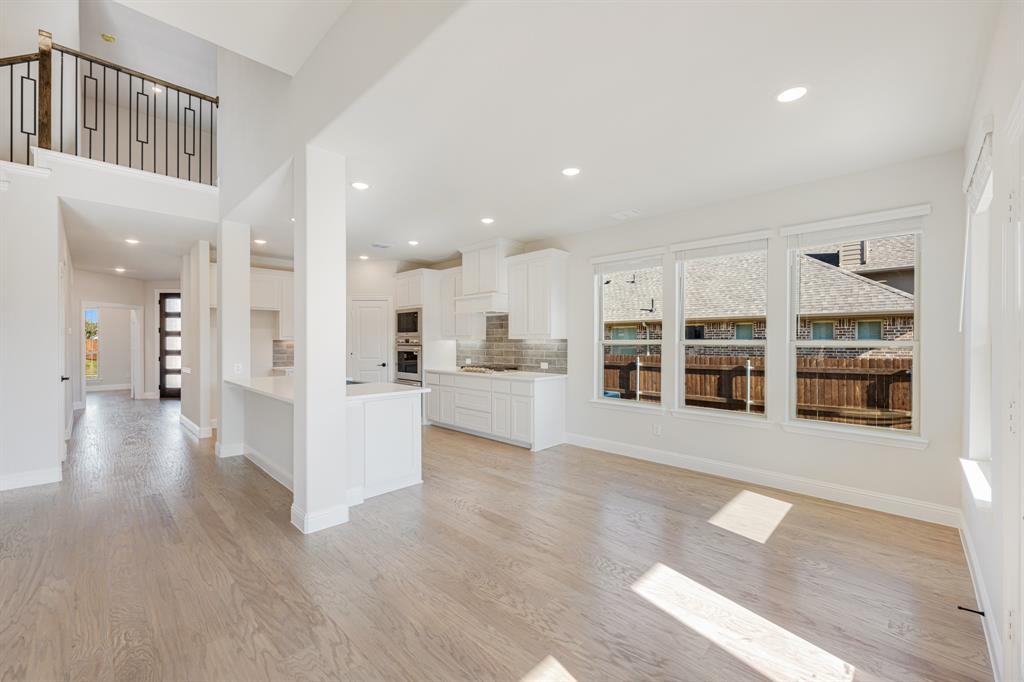 2505 Rileigh Lane Mansfield, TX 76063 - Photo 13 of 40 a view of a big room with wooden floor and windows