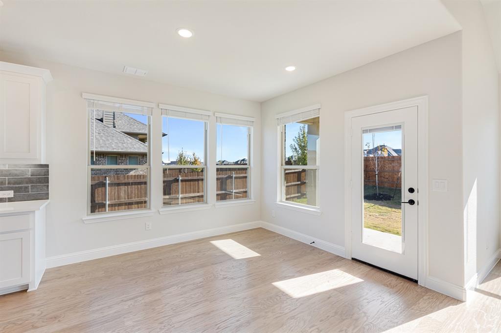 2505 Rileigh Lane Mansfield, TX 76063 - Photo 14 of 40 an empty room with wooden floor and windows